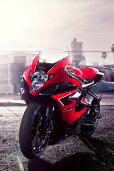 a red motorcycle is parked on the street