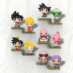 the dragon ball figurines are lined up on a white marble surface, with different colors