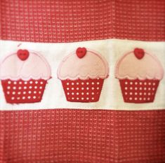 three cupcakes on a red and white towel