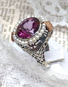 Natural Pink Topaz Ring Round Pearl Design#238 Custom Made This is a stunning Victorian reproduction in sterling silver filigree with a natural 6.5ct pink topaz round bezel stone... The stunning stone is 12 mm...The ring sits 21 mm NS by 17 mm EW... The inside of the band is marked 925 for sterling. Notice the beautiful craftsmanship of the silver filigree setting and band. The small natural pearls are 2 mm wide notice the two rose gold flowers on the top and bottom of the setting... The ring is Victorian Wedding Jewelry With Gemstone Accents, Victorian Style Topaz Ring For Gift, Victorian Topaz Ring With Accent Stones As Gift, Victorian Topaz Gemstone Ring For Gift, Victorian Style Topaz Gemstone Ring Gift, Victorian Style Topaz Ring As Gift, Handmade Elegant Topaz Ring For Anniversary, Elegant Handmade Topaz Ring For Anniversary, Elegant Handmade Topaz Ring For Formal Occasions