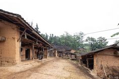 an old dirt road next to some buildings