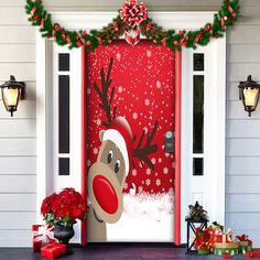 a door decorated with christmas decorations and reindeers