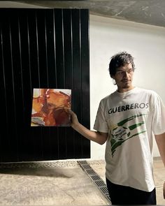 a man holding up a piece of art