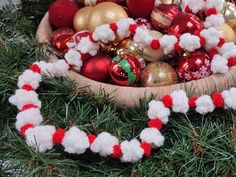 a wooden bowl filled with ornaments on top of a table