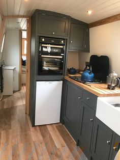 a kitchen with gray cabinets and white appliances