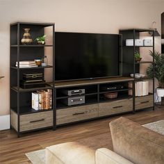 a living room with a large television on top of a wooden entertainment center next to a couch