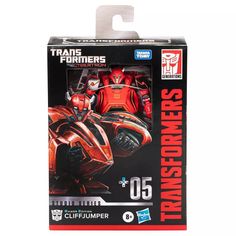 a toy figure in the packaging for a transformer movie character series, with an orange and