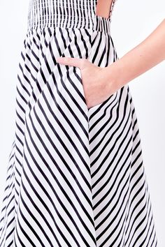 A perfect example of playful meets pretty, our Striped Smocked Dress is perfect for any summertime activity. The fun and flirty striped print is accented by an elastic detailed back and smocked bodice. The midi length provides just the right amount of coverage, while the fully lined skirt ensures utmost comfort. No matter where your day takes you, this dress will have you looking and feeling your best. Striped print Elastic detailed back Smocked bodice Midi length Fully lined Hand wash cold Do not bleach Do not tumble dry Iron low Shell: 100% Cotton Lining: 80% Polyester 20% Cotton TL768D Total length:46" Bust:31" S Height 5'8"(173cm) / Bust 32"(81cm) / Waist 25"(67cm) / Hip 35"(89cm) Striped Vacation Dress With Smocked Back, Striped Dress With Smocked Back For Vacation, Summer White Dress With Vertical Stripes, Striped Summer Daywear Dress, Striped Beach Dress With Smocked Back, Striped Summer Dress For Daywear, Striped Summer Dresses For Daywear, Chic Striped Lined Midi Dress, Striped Lined Dress For Day Out