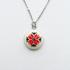 Beautiful hand embroidered necklace, with a traditional Romanian red and black motif. Perfect for everyday wear or a special occasion. * Pendant: 2.5 cm x 2.5 cm * Embroidered part: 2 cm* Chain length: measures between 43 cm - 76 cm (17"-30") depending on your choice (You can choose your desired necklace length from the drop-down menu. Leave a note at checkout for any custom length. )*cotton fabric*stainless steelThe embroidery is protected from moisture and dirt by professional impregnateFind m Red Necklaces With Motifs For Gifts, Bohemian Necklaces With Motifs As Gift, Bohemian Necklaces With Motifs For Gift, Silver Necklace With Motifs For Gift, Handmade Red Medallion Necklace, Traditional Embroidered Necklace For Gift, Embroidered Pendant Necklace For Gift, Traditional Red Medallion Necklace, Handmade Folk Jewelry As Gift