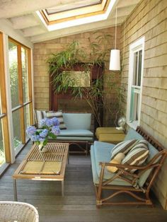 a porch with furniture and plants on it