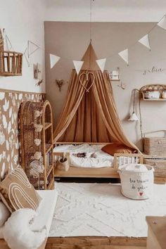 a bedroom decorated in white and brown with lots of decorations on the walls, bedding and pillows