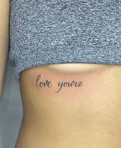 a woman's stomach with the word love youz written on it, in cursive font