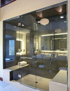 a bathroom with a large glass shower door