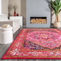 a living room with a pink rug and fire place