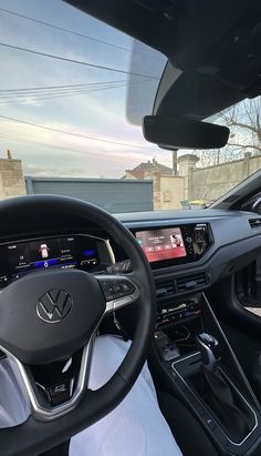 the interior of a car with dashboard, steering wheel and electronic display on it's screen