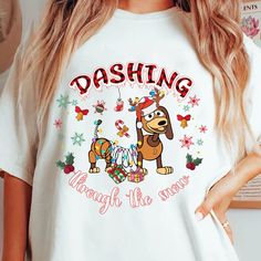 a woman wearing a white tshirt that says dashing through the snows