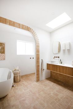 a large bathroom with two sinks and a bathtub