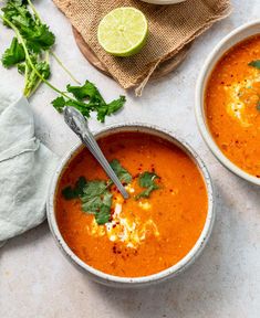 two bowls filled with soup and garnished with cilantro