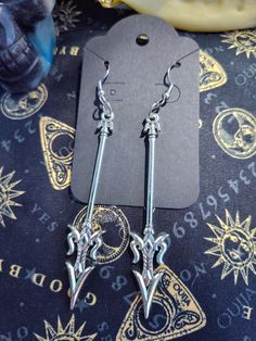 These sword earrings are not as dangerous as they look. Whether you're into D&D or spooky vibes these are the earrings for you. Hardware can be changed out to hypoallergenic (stainless steel) for a fee. Send me a message to initiate. Silver Metal Earrings For Cosplay, Silver Pierced Earrings For Cosplay, Silver Earrings For Cosplay, October Jewelry, Portsmouth Va, Spooky Vibes, Portsmouth, Fashion Earrings, Halloween Shopping