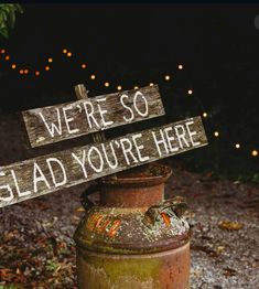 a rusted out fire hydrant with a sign that says we're so glad you're here