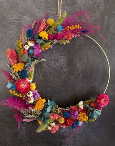 a wreath made out of flowers and feathers