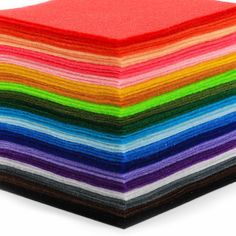 a stack of multicolored papers stacked on top of each other in different colors