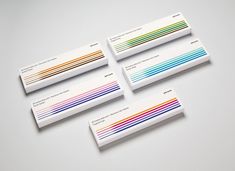 four business cards with different colored lines on them