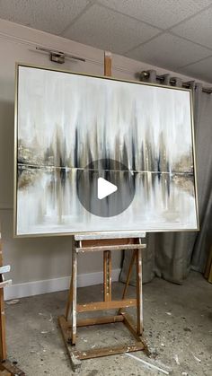 an easel with a large painting on it