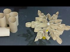 an ornament made out of toilet paper and rolled up rolls on a table