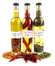 three bottles filled with different types of spices