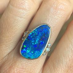 How much do we love this incredible solid Australian Opal? Emily is OBSESSED with finding the best Opals and over the years has found some incredible specimens and this one is no exception. We set her in 14k yellow gold with a gold freeform band and a bevy of brilliant cut white diamonds on its shoulders. Approx stone size: 23mm x 13.5mm Opal ct weight: 9.9cts Diamond ct weight: .26cts This one of a kind piece is handmade in Emily's Hudson Valley studio. This piece is in stock and currently a si Blue Opal Ring In 14k Gold For Formal Occasions, Fine Jewelry 14k Gold Pear-shaped Opal Ring, 14k Gold Pear-shaped Opal Ring, Unique Formal Opal Ring In 14k Gold, 14k Gold Pear-shaped Opal Ring Fine Jewelry, Unique 14k Gold Opal Ring For Formal Occasions, Pear-shaped 14k Gold Opal Ring Fine Jewelry, Pear-shaped 14k Gold Opal Ring, Vvs Clarity Opal Ring For Formal Occasions