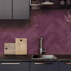 a kitchen with purple tiles and wooden cabinets in the back ground, along with a cutting board on the counter