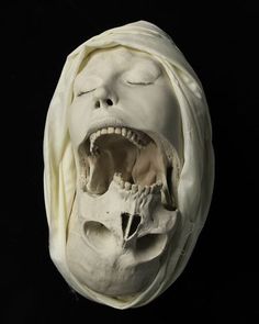 a white mask with an open mouth and teeth