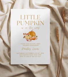 a little pumpkin is on the way baby shower card with gold foil lettering and an autumn theme