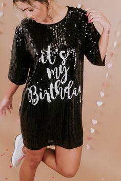 Party like it's your birthday! The It's My Birthday Sequin Dress features a round neckline, a stunning sequin design, a full lining, and the text " It's My Birthday" across the front in white. The ideal dress to accessorize and wear out on your big day! Short sleeves Round Neckline Above the knee hemline Sequin Pattern both front and back Full lining - not itchy at all Fit: oversized Fabric: 65% Polyester, 30% Cotton, 5% Spandex Imported Model Specs: Emily is wearing a size small in the photo.How will this item fit you? Check out our MODEL SPECS (Typical Sizing - Karli: S-Size 5/26 - 5ft 2in, Emily: S-Size 3/25 - 5ft 5in, Syd: L/XL- Size 15/ - 5ft 8in)Need help with sizing? No problem! Join our VIP group on Facebook, Everyday Chic Boutique VIP Insiders to chat directly with our team and ot Birthday Sequin Dress, Sequin Dress Black, Sequin Pattern, It's My Birthday, Sequin Design, Vip Group, Everyday Chic, Black Sequin Dress, Bride Tribe