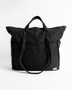 Whether you're headed to the beach, or to visit the farmers market, or maybe even just out for the day, the Schoolyard Canvas Tote is a great choice. It's lightweight, offers a comfortable shoulder carry, and has plenty of space for all the essentials.  Featured here in new black. - Features

 - 18.5" X 20.5" X 6"
 - Large Main Compartment withZip Pocket
 - Dual Front Zip Pockets
 - Side Slip Pockets
 - Woven Patch Label Casual Weekender Bag With Pockets, Casual Everyday Tote Weekender Bag, Black Softback Canvas Bag For Everyday Use, Casual Weekender Bag With Pockets For Everyday, Casual Weekender Bag With Adjustable Strap For Everyday Use, Black Cotton Weekender Bag With Large Capacity, Travel Canvas Tote Bag With Adjustable Straps, Casual Travel Bag With Reinforced Handles, Casual Weekender Bag With Large Capacity