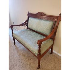 a wooden bench sitting on top of a carpeted floor