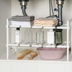 a bathroom shelf filled with toiletries and cleaning supplies next to a sink under a faucet