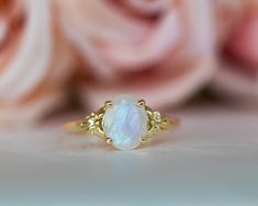 This is an oval moonstone ring, vintage style moonstone engagement ring, solitaire ring, moonstone engagement ring, gemstone ring, moonstone gold ring, oval engagement ring, a perfect moonstone engagement ring. This vintage style floral ring and has a dainty and feminine design, a solitaire vintage style with a natural oval rainbow moonstone, that symbolizes passion and endless love. This unique engagement ring is the best way to show your pure love for the one you love. ♥ Moonstone Gemstone mea Yellow Gold Moonstone Cabochon Ring For Wedding, Yellow Gold Cabochon Moonstone Wedding Ring, Heirloom Yellow Gold Moonstone Ring, Oval Cabochon, Heirloom Yellow Gold Oval Cabochon Moonstone Ring, Heirloom Yellow Gold Moonstone Ring, 14k Gold Cabochon Moonstone Ring For Wedding, Anniversary Moonstone Ring With Rose Cut Diamonds, Oval Moonstone Gemstone Ring, Fine Jewelry Cabochon Moonstone Ring For Anniversary