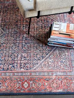 a pile of books sitting on top of a rug