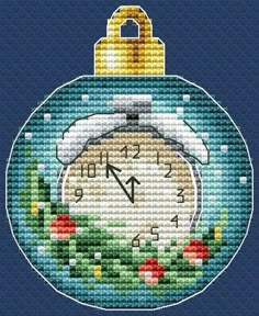 a cross stitch christmas ornament with a clock