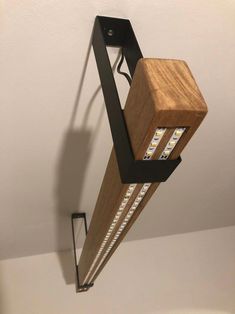 a wooden light fixture hanging from the ceiling