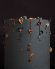 a close up of a cake with flowers on the icing and decorations hanging from it