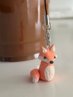 a key chain that has a small fox on it