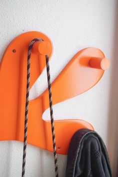 an orange wall mounted coat rack with two hooks