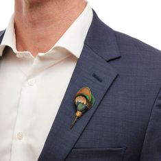 Layers of peacock and pheasant are combined for a sophisticated color palette that showcases the soft iridescence of each feather in the Pioneer lapel pin. Elegant Multicolor Brooches For Formal Occasions, Elegant Peacock Design Brooch For Formal Wear, Elegant Multicolor Brooch Pins, Elegant Peacock Design Brooch For Formal Occasions, Elegant Peacock-colored Brooches For Wedding, Elegant Peacock Brooches For Wedding, Elegant Peacock Color Wedding Brooches, Elegant Peacock Color Party Brooches, Elegant Green Lapel Pin For Wedding