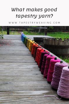 colorful spools of yarn sitting on top of a wooden table with the words, what makes good tapestry yarn?