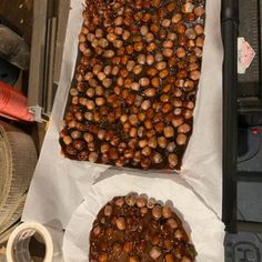 two trays filled with nuts sitting on top of a table