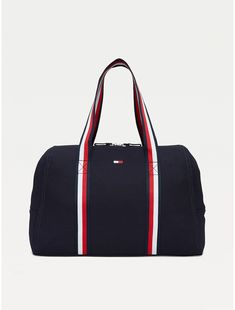 Tommy Hilfiger women's bag. Practicality and standout style come together in this spacious zip tote, showcasing our signature stripes at the handles for a branded finish.  Material: 100% Cotton. Sporty Canvas Gym Bag, Navy Sporty Bag With Zipper Closure, Sporty Navy Bag With Zipper Closure, Sporty Canvas Bag With Zipper Closure, Sporty Canvas Bags For On-the-go, Everyday Tommy Hilfiger Bag With Zipper Closure, Sporty Cotton Travel Bag, Tommy Hilfiger Travel Bags With Zipper Closure, Sporty Rectangular Cotton Bag