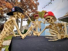 two skeletons sitting on top of a black table